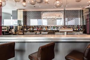 a bar in a restaurant with two chairs at Premier Inn Stuttgart City Centre in Stuttgart