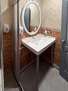 a bathroom with a sink and a mirror at Tiana Beach Resort in Turgutreis