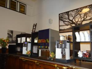 a counter in a room with several vending machines at Tulip Inn Heerlen City Centre in Heerlen