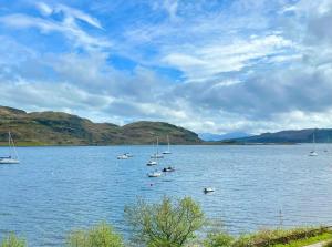 a group of boats on a large body of water at Burnside in Tighnabruaich
