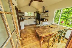 a kitchen and dining room with a wooden table and chairs at Rivers Breeze A Wine Country Escape in Healdsburg