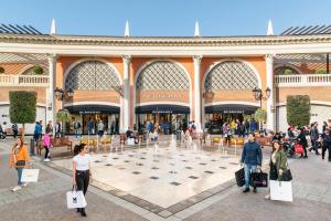 a group of people walking in front of a shopping mall at Casa Elena in Torvaianica