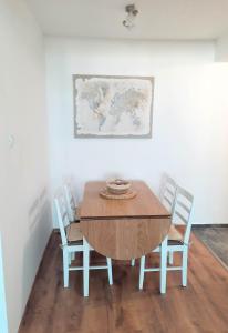 a dining room with a wooden table and chairs at Seaview Serenity Apartment in Burgas City