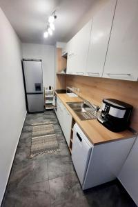 a kitchen with a sink and a refrigerator at Seaview Serenity Apartment in Burgas City