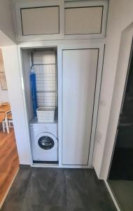 a laundry room with a washer and dryer in it at Seaview Serenity Apartment in Burgas City