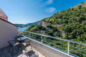 a balcony with chairs and a view of a mountain at Peaceful apartment near the beach - Sole in Zaton