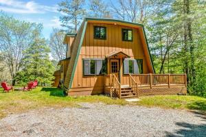 a tiny house in the woods with a front porch at Sleeps 8! Fire Pit, Games, 15 Mins from Downtown Blue Ridge in Mineral Bluff