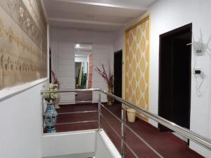 a hallway with stairs and a painting on the wall at Helen One Hotel in Lahore