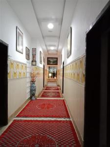 a hallway with a red carpet on the floor at Helen One Hotel in Lahore