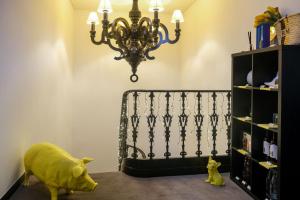 a room with a chandelier and a toy pig on the floor at RM The Experience - Small Portuguese Hotels in Setúbal