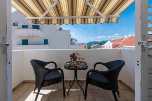 a balcony with a table and two chairs at Apartment Soulmate in Dubrovnik