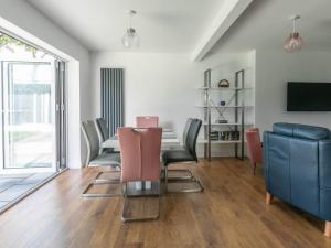 a dining room with a table and chairs at Seaside Family Bungalow for 5 people with garden and driveway parking in Kent