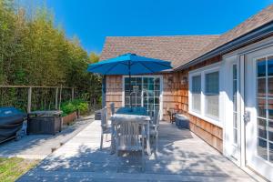 a patio with a table and an umbrella at 15 Seneca in Ocean Bay Park