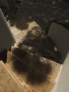 a set of stairs in a building with the sun shining w obiekcie Quomorari w mieście Barletta