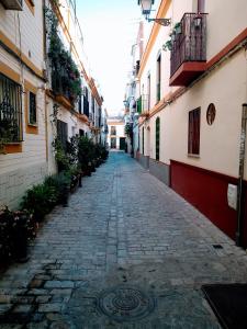 an alley way between buildings in an old town at Azahar in Seville