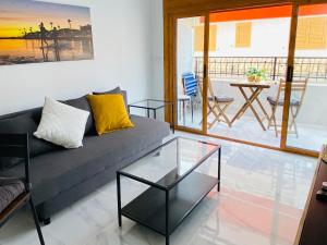 a living room with a couch and a glass table at LOVELY Sunset in Santa Pola