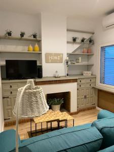 a living room with a blue couch and a fireplace at Casita pueblo al lado Del Mar-Vilasardemarlux4 in Vilassar de Mar