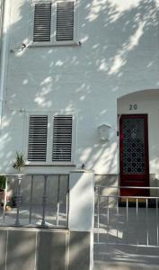 a white building with a red door and a balcony at Casita pueblo al lado Del Mar-Vilasardemarlux4 in Vilassar de Mar +52 photos