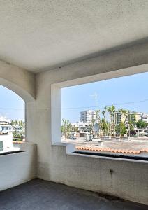 - une fenêtre dans un bâtiment avec vue sur la ville dans l'établissement Casa sul mare anni 60, à Misano Adriatico