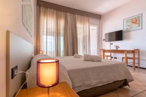 A bed or beds in a room at Residence Le Vele
