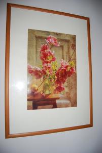 a painting of flowers in a vase on a table at Apartment Stepana Bandery Street in Rivne