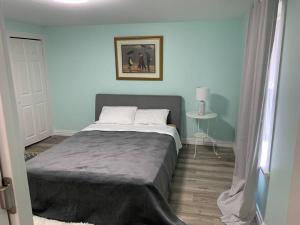 a bedroom with a large bed in a room at Crystal BeachHouse-new reno 3Br wifi smart tv in Fort Erie