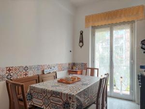 a dining room with a table and a window at House Mamma Marisa by Holiday World in Genoa