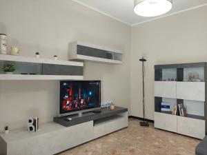 a living room with a flat screen tv on a wall at House Mamma Marisa by Holiday World in Genoa