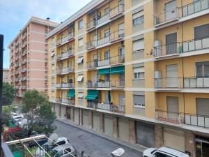 an apartment building with cars parked in a parking lot at House Mamma Marisa by Holiday World in Genoa