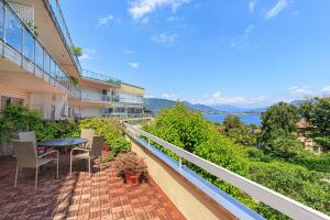 a balcony of a building with a table and chairs at Maravilla - By Impero House in Baveno