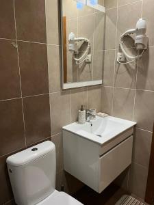 a bathroom with a white toilet and a sink at Casa do Javali in Bragança +36 photos
