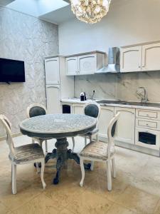 a kitchen with a table and chairs in a kitchen at Casa belvedere luxury in Anzio