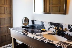 um balcão de casa de banho com um lavatório e um espelho em The Morgan Hotel Martha's Vineyard em Oak Bluffs