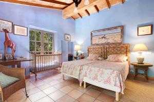 a bedroom with a bed and a chair and a window at La Casa del Molino de Viento in Agaete +32 photos