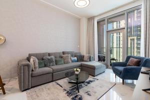 a living room with a couch and a table at White Sage - Amna Tower in Dubai