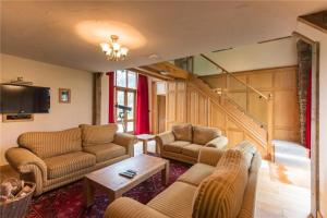 a living room with two couches and a tv at Baddegai Holiday Cottage in Brecon