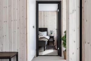 a hallway with a bed in a room with wooden walls at Lovely winter cottage in Vemdalen, close to skiing in Vemdalen