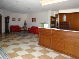 a waiting room with red couches at Hotel Ristorante111 in Villapiana