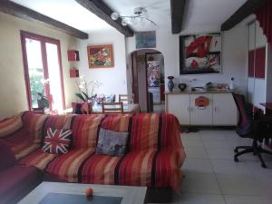 a living room with a couch and a table at VILLA DE CHARME sur la Côte d'Azur in Tourrette-Levens