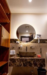 a bathroom with a sink with a large mirror at Marron studios 1 new in Cairo