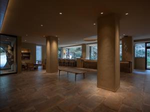 a lobby with a table and a bench in a building at moksa in Kyoto