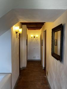 a hallway in a house with a mirror and lights at Fattoria Montignana in San Casciano in Val di Pesa