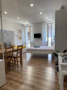 a living room with a bed and a dining table at Holiday Studio in Centro Storico Intra in Intra