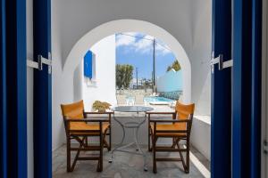 a patio with a table and chairs and a pool at Hotel Bilia in Naousa