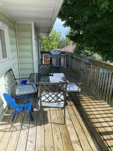 a deck with a table and chairs and a grill at The Water Street Inn in Napanee