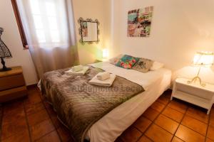 a bedroom with a bed with two towels on it at Casa da Praia by AcasaDasCasas in Santo Isidoro