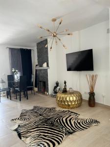 a living room with a zebra rug on the floor at Real de la Barrosa in Chiclana de la Frontera