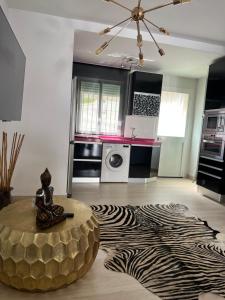 a living room with a zebra print rug and a table at Real de la Barrosa in Chiclana de la Frontera