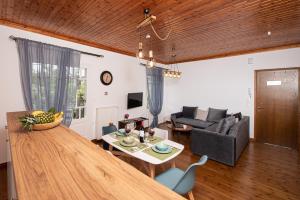 a living room with a table and a couch at Perispit in Lefkada