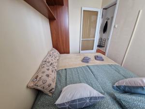 a small bedroom with a bed with two pillows at Casa Cristina in Pécs +16 photos